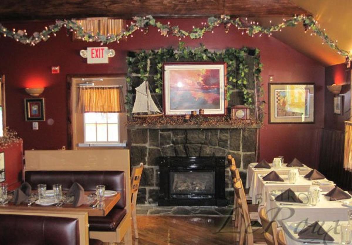 Inside of Bistro LeRoux, tables and fireplace