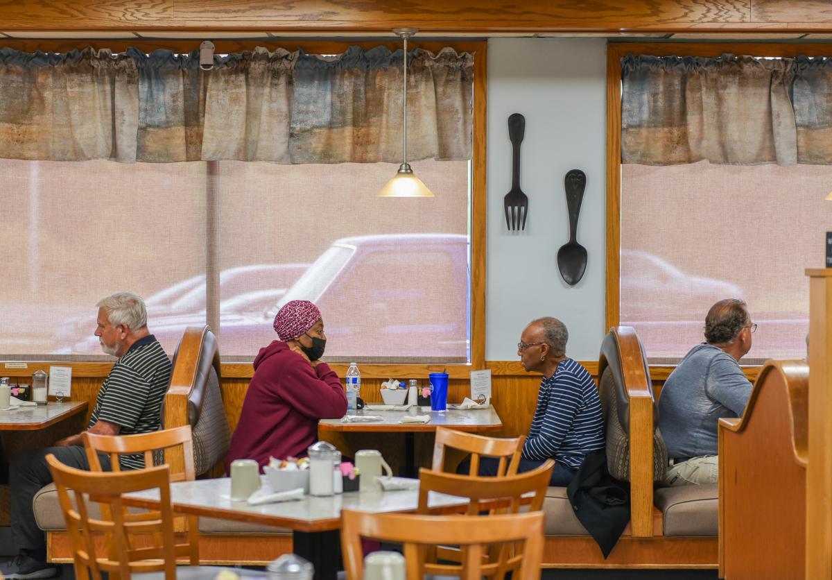 Two people dine in together in a booth at a restaurant