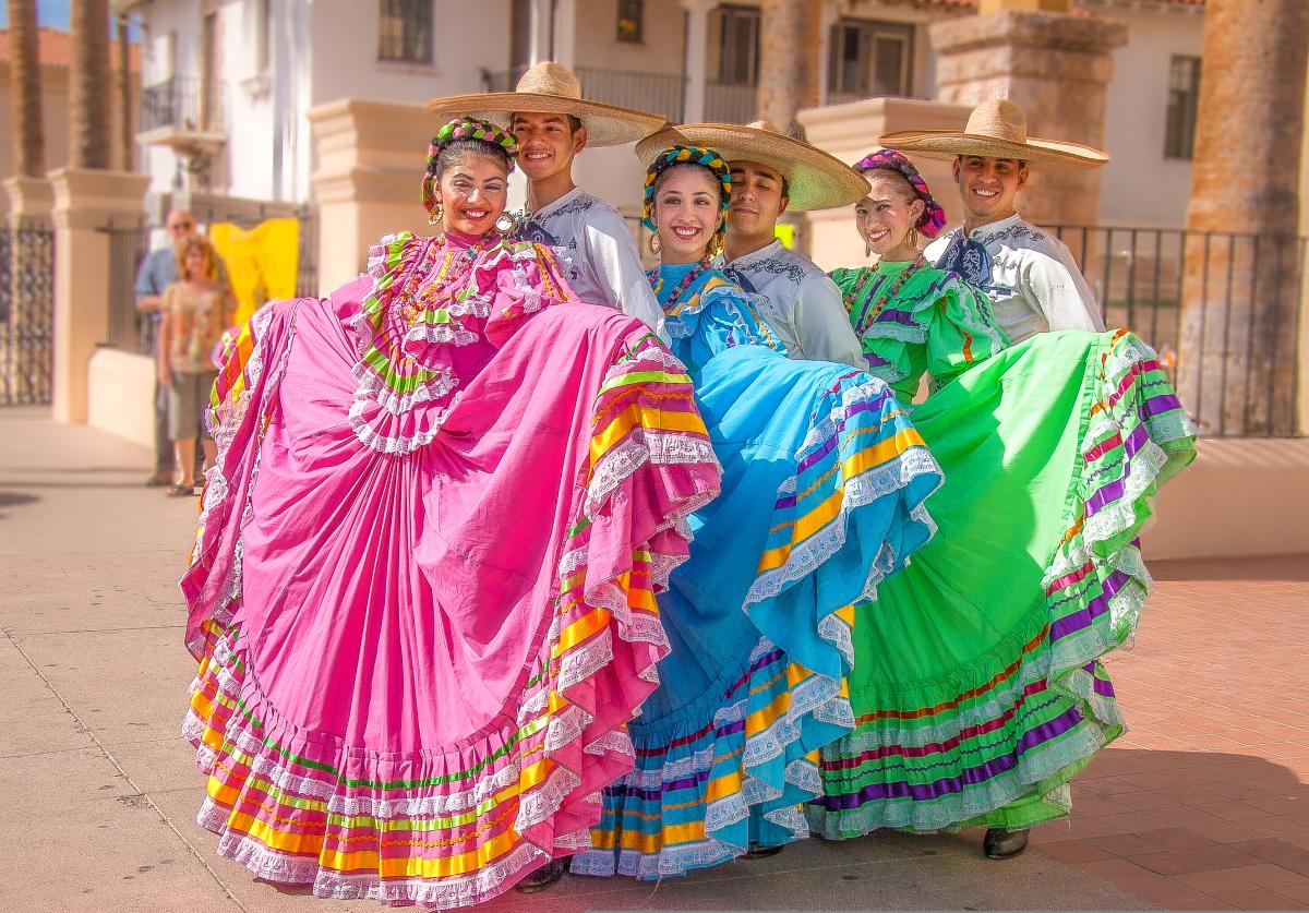 Traditional Mexican Dancers in bright, colorful dresses and sombreros