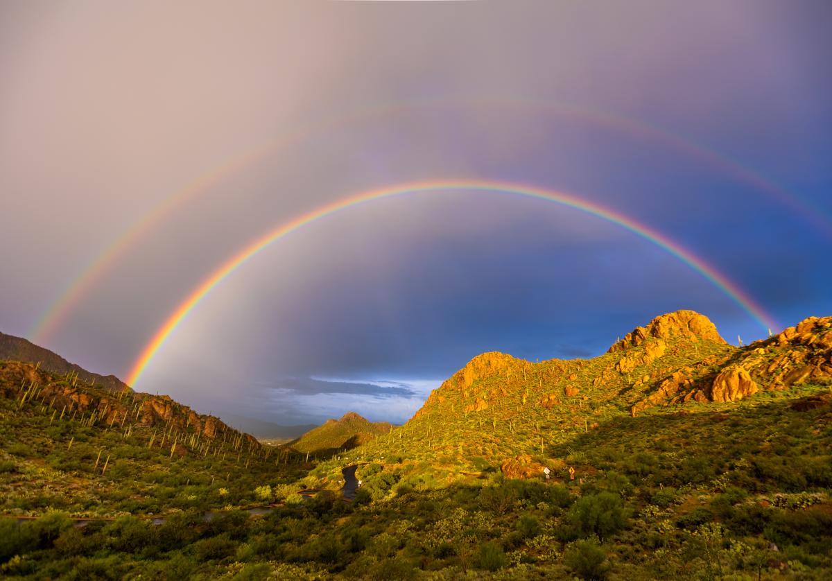 Double rainbow over desert mountains