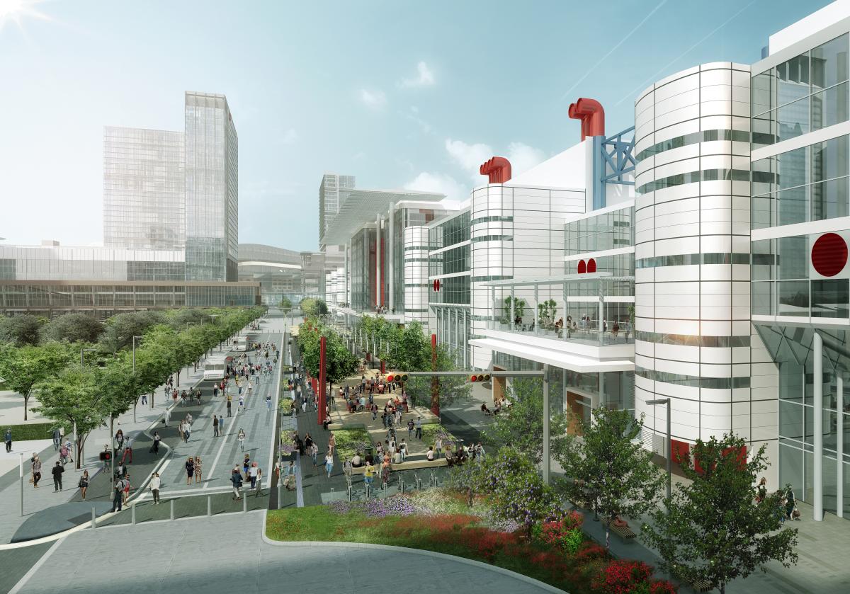 Street view of people attending an event at the George R. Brown Convention Center in Houston, Texas, with trees and city view in the background.