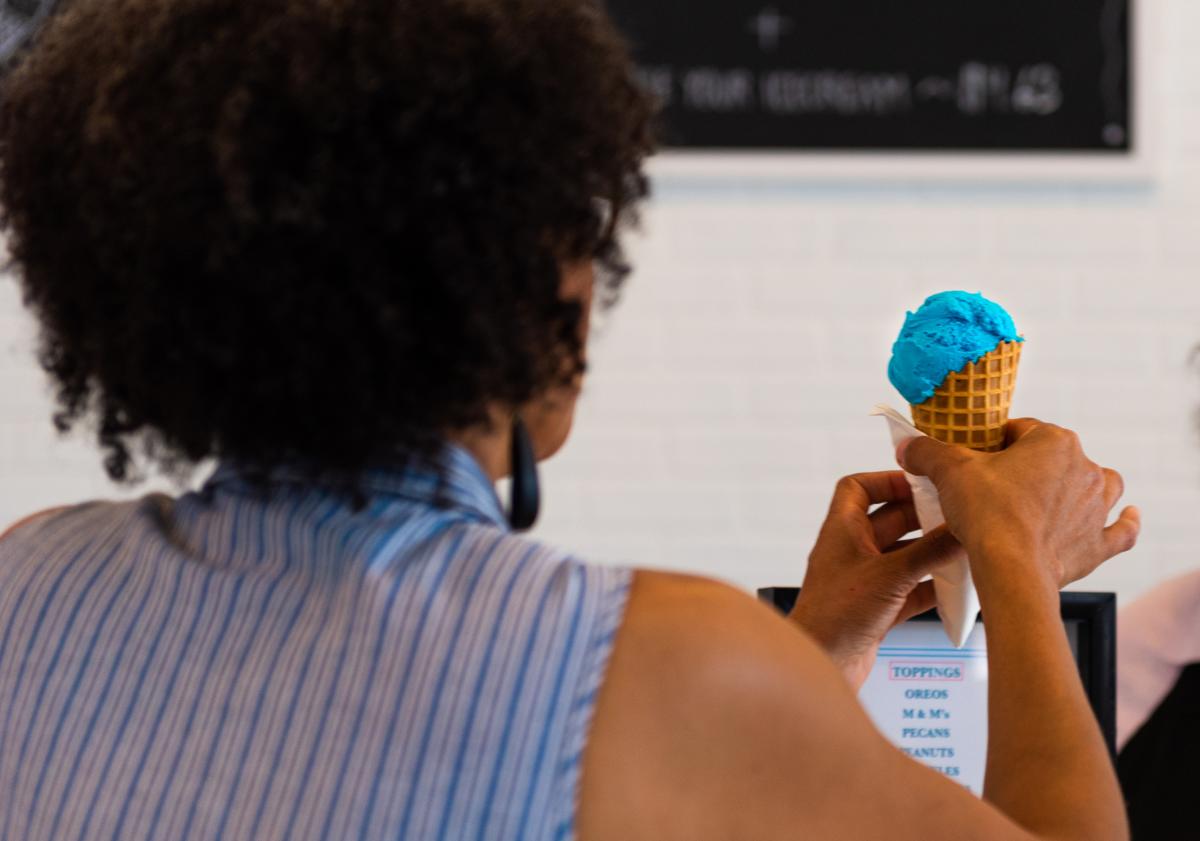 A woman holding an ice cream cone at Sweets on Main in downtown Fort Wayne, Indiana