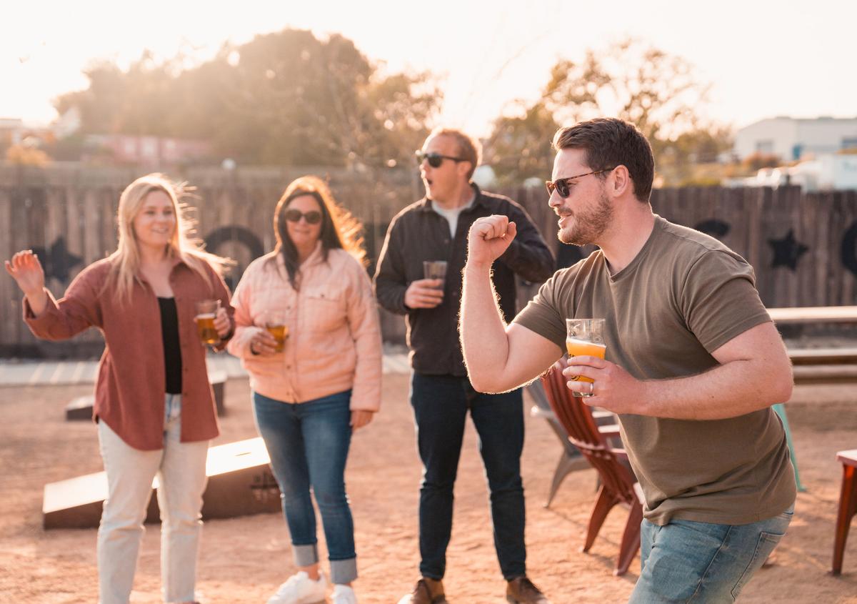 group of friends playing cornhole at Barrelhouse Brewing in Paso Robles