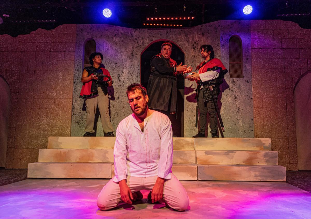 An actor rests on his knees while playing Jesus during a scene of Jesus Christ Superstar at Roxy's Downtown.