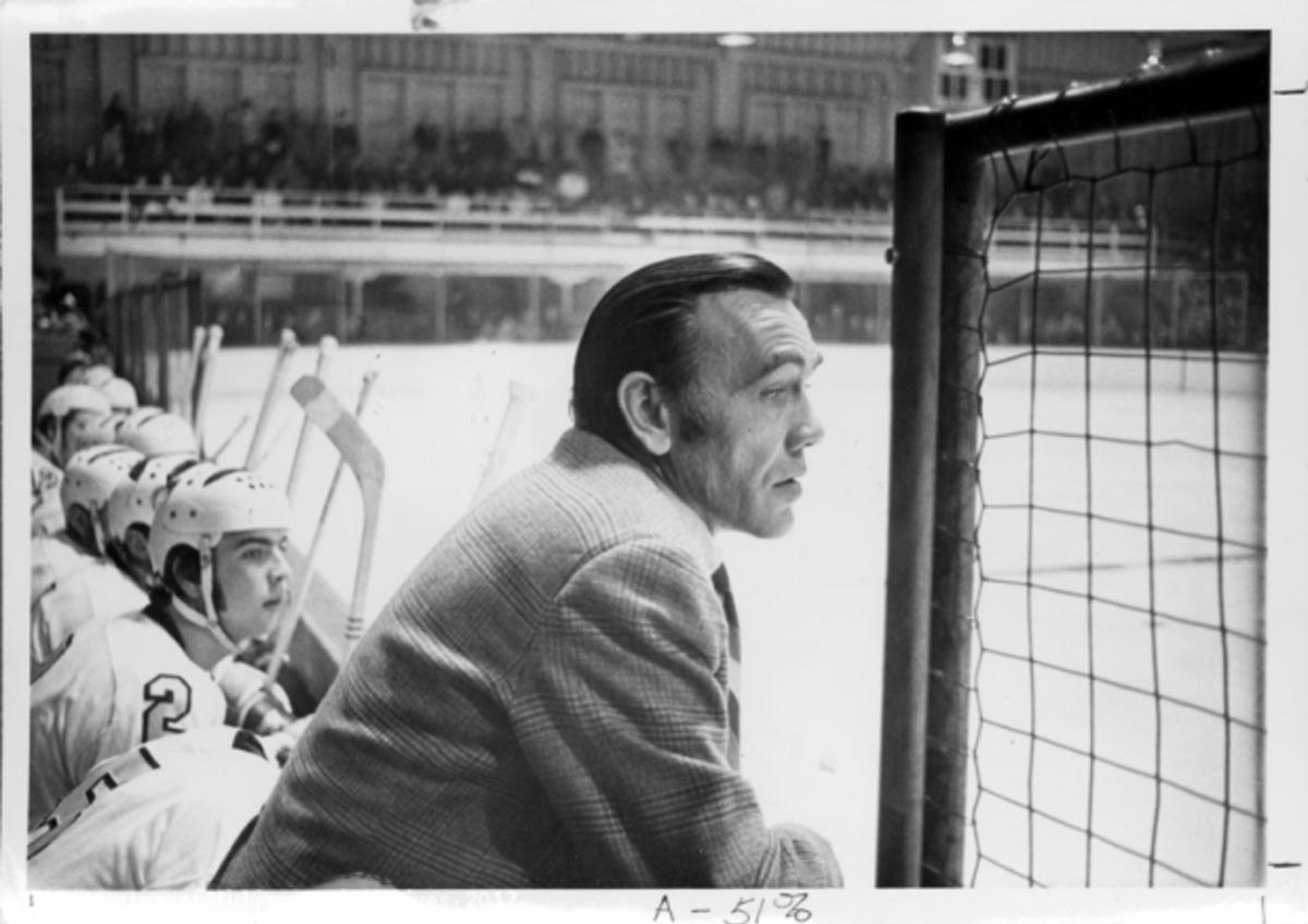 Coach John MacInnes paying attention to game.