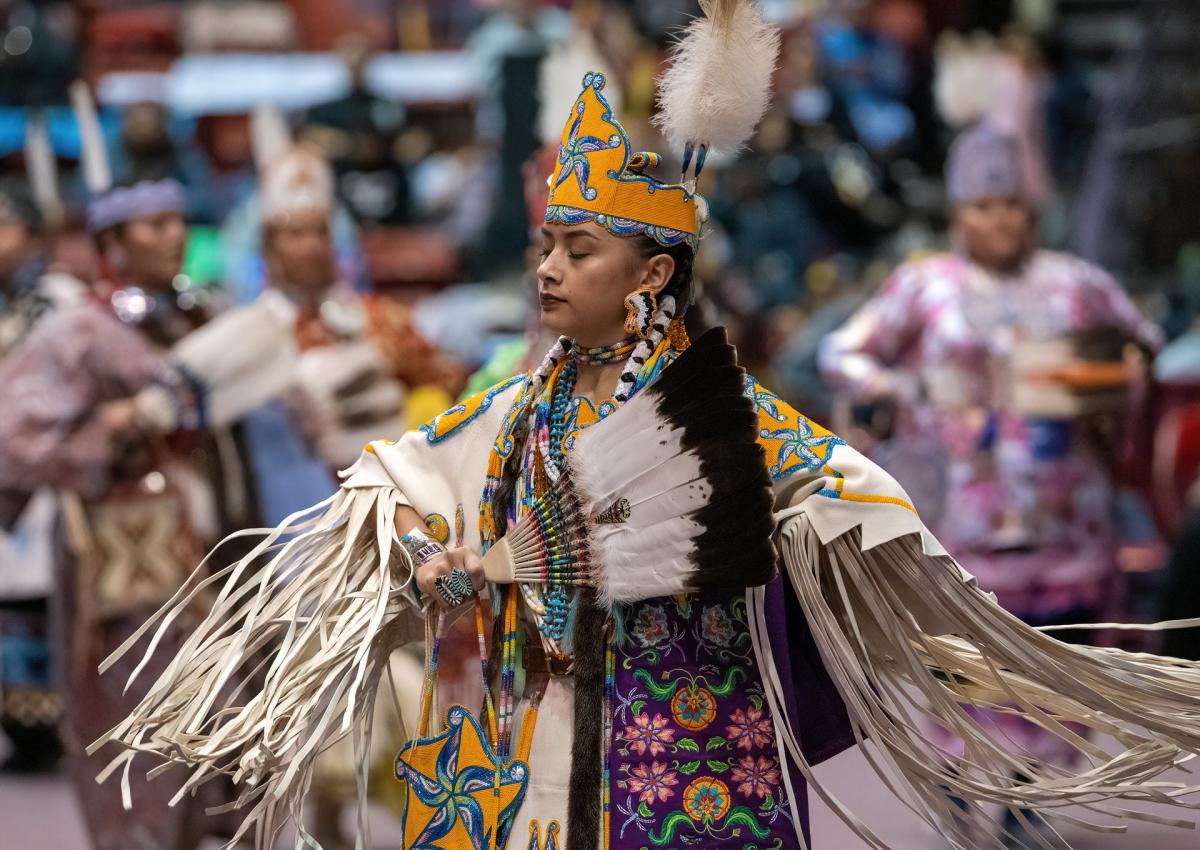 women's traditional dancer performing at the black hills powwow in rapid city, sd