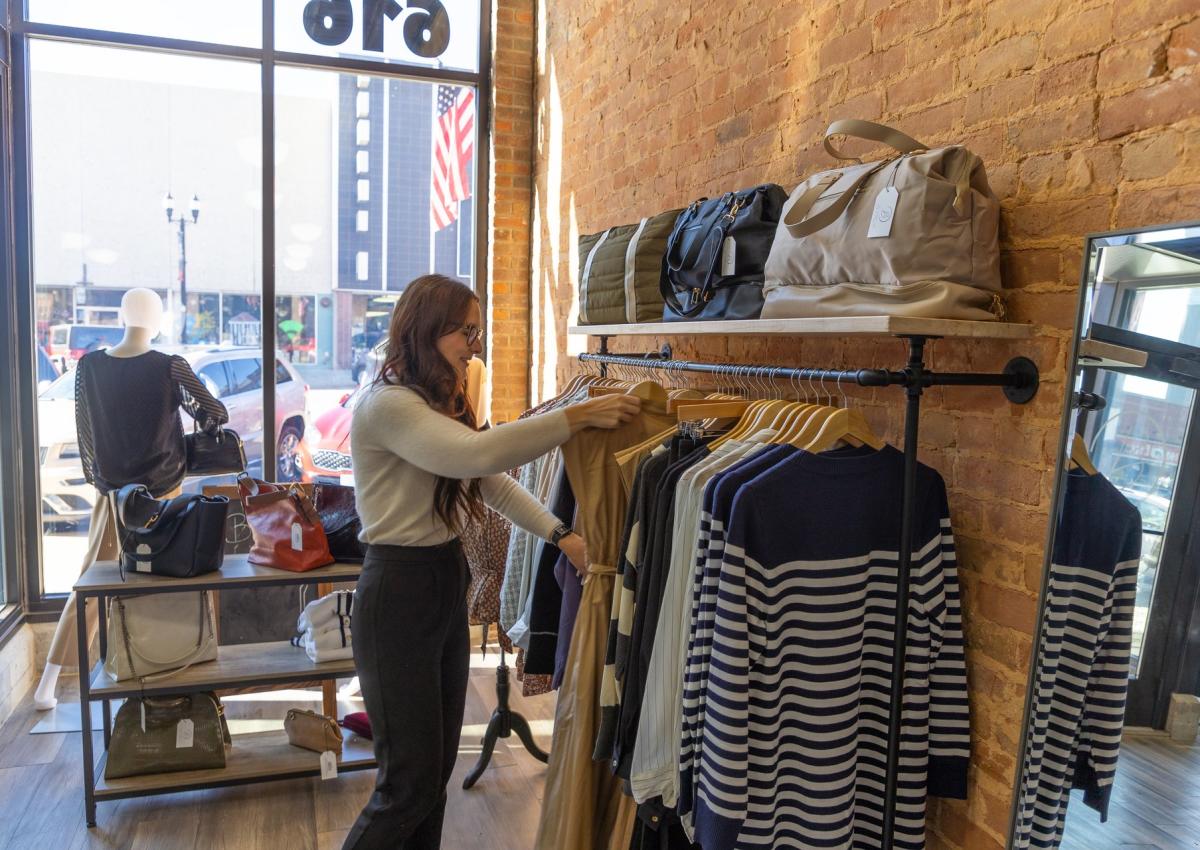 person shopping the clothing rack of byrch boutique in downtown rapid city, sd