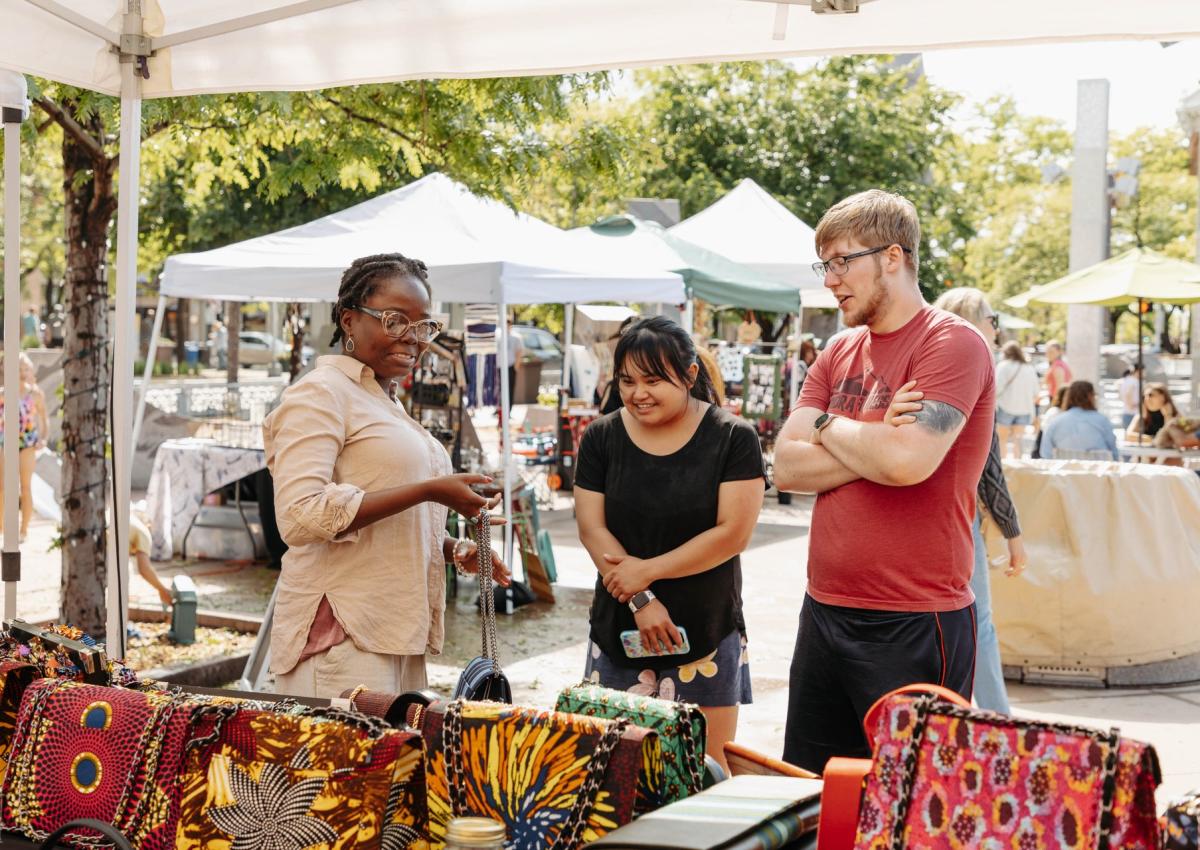vendor in main street square with booth visitors during the Fruhlingsfest event in rapid city,sd