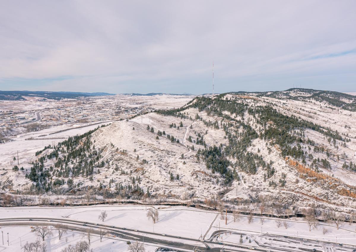 a drone shot of a snow covered hanson larsen memorial park in rapid city, sd
