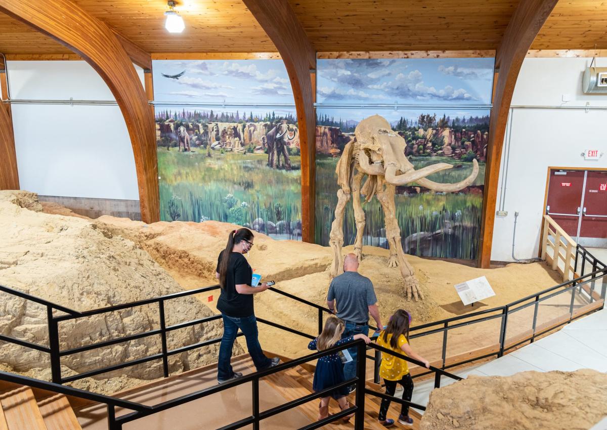 family touring the mammoth site of hot springs in south dakota