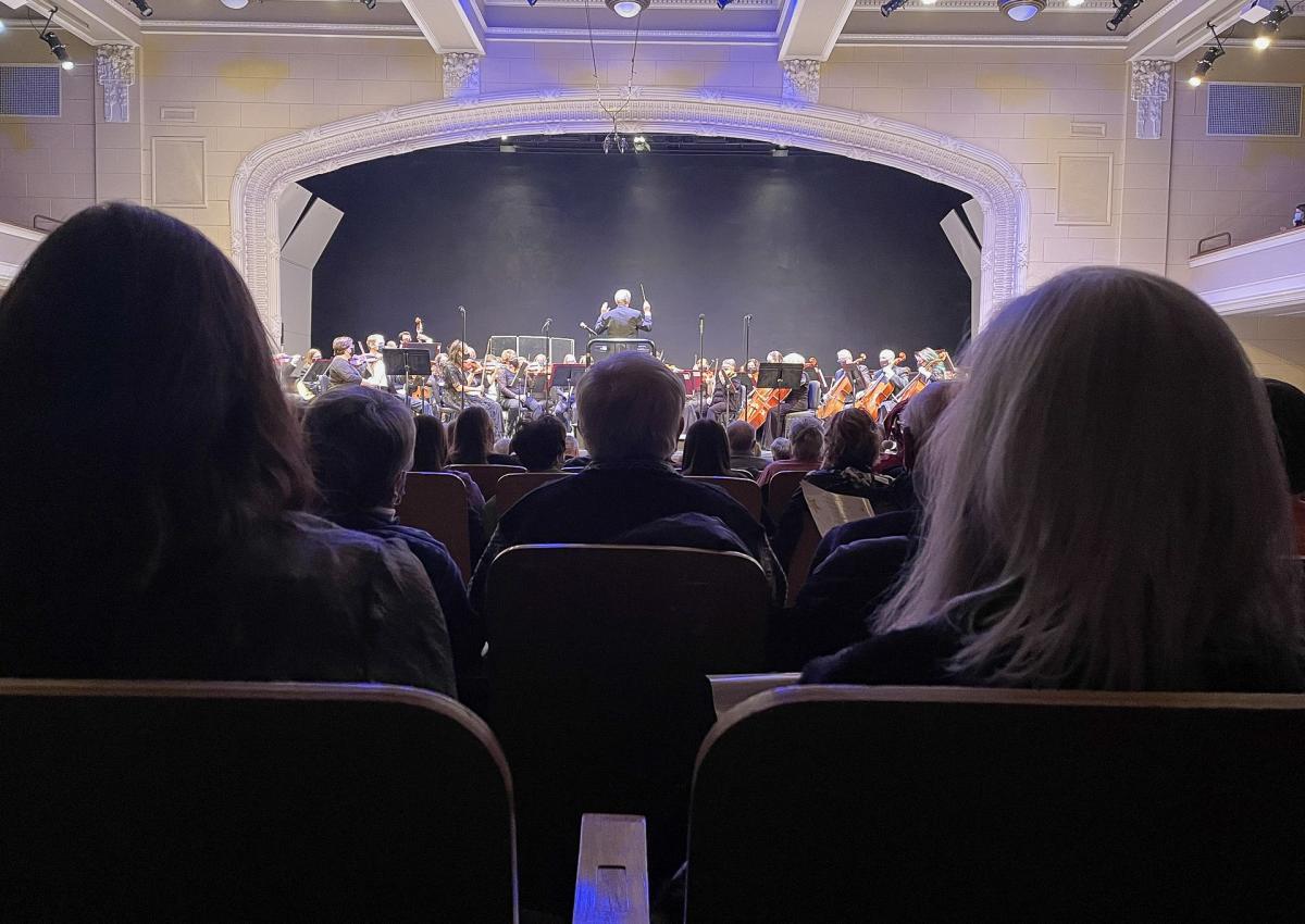 audience members watching a performance of the black hills symphony orchestra in rapid city, sd