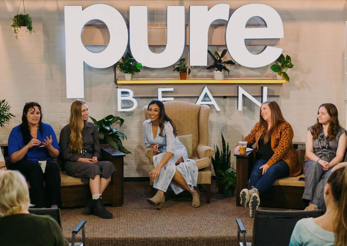 Speakers on the stage in the pure bean coffee house event space