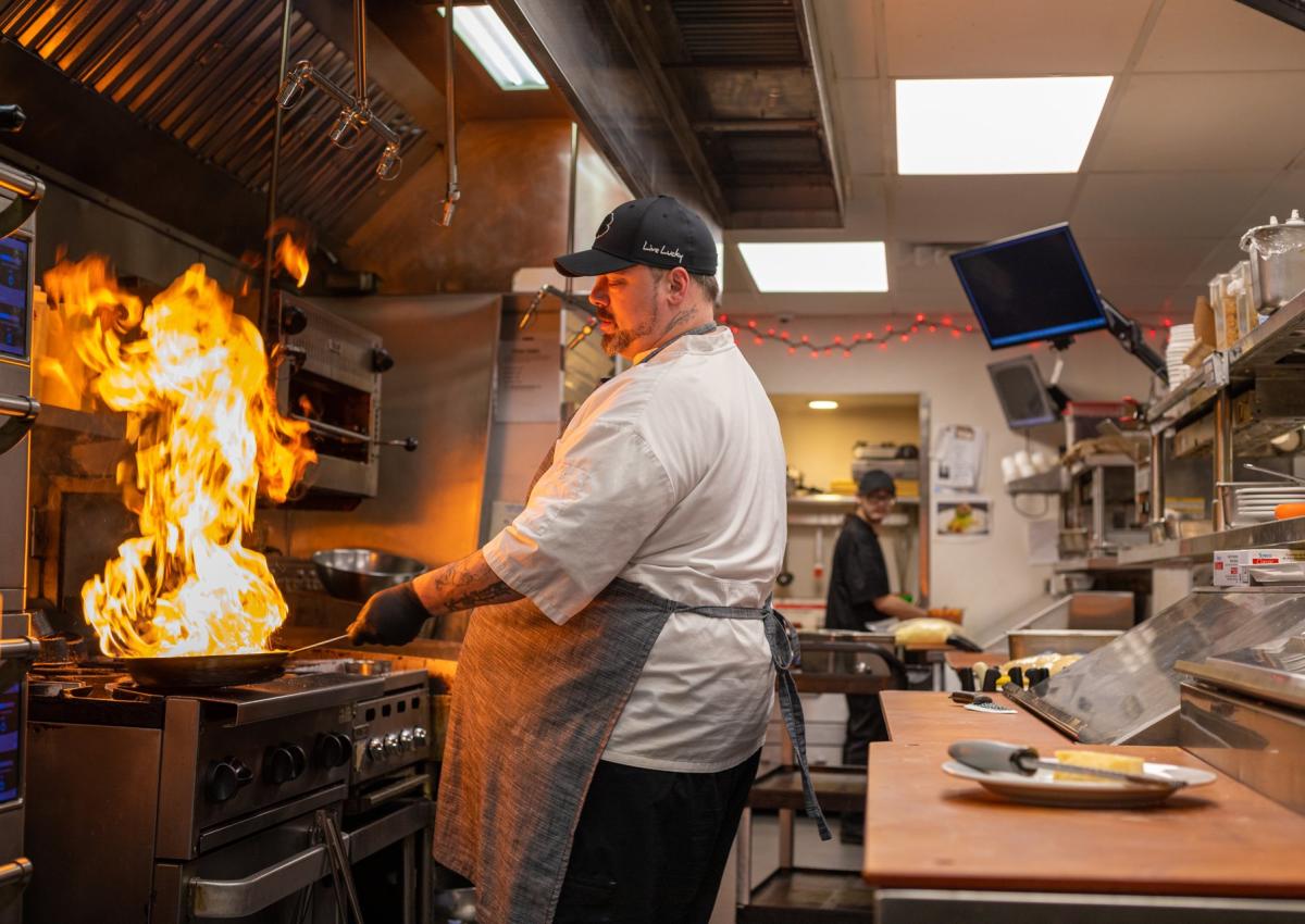 chef cooking with a pan on fire at a restaurant in rapid city, sd