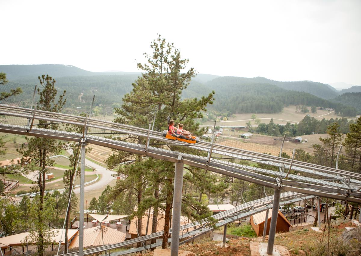 mountain coaster views of the black hills as two riders enjoy rush mountain adventure park