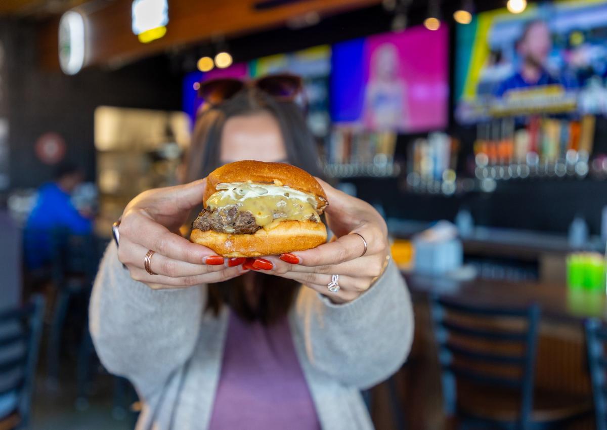 person holding up burger from salt block burger and brews in rapid city, sd