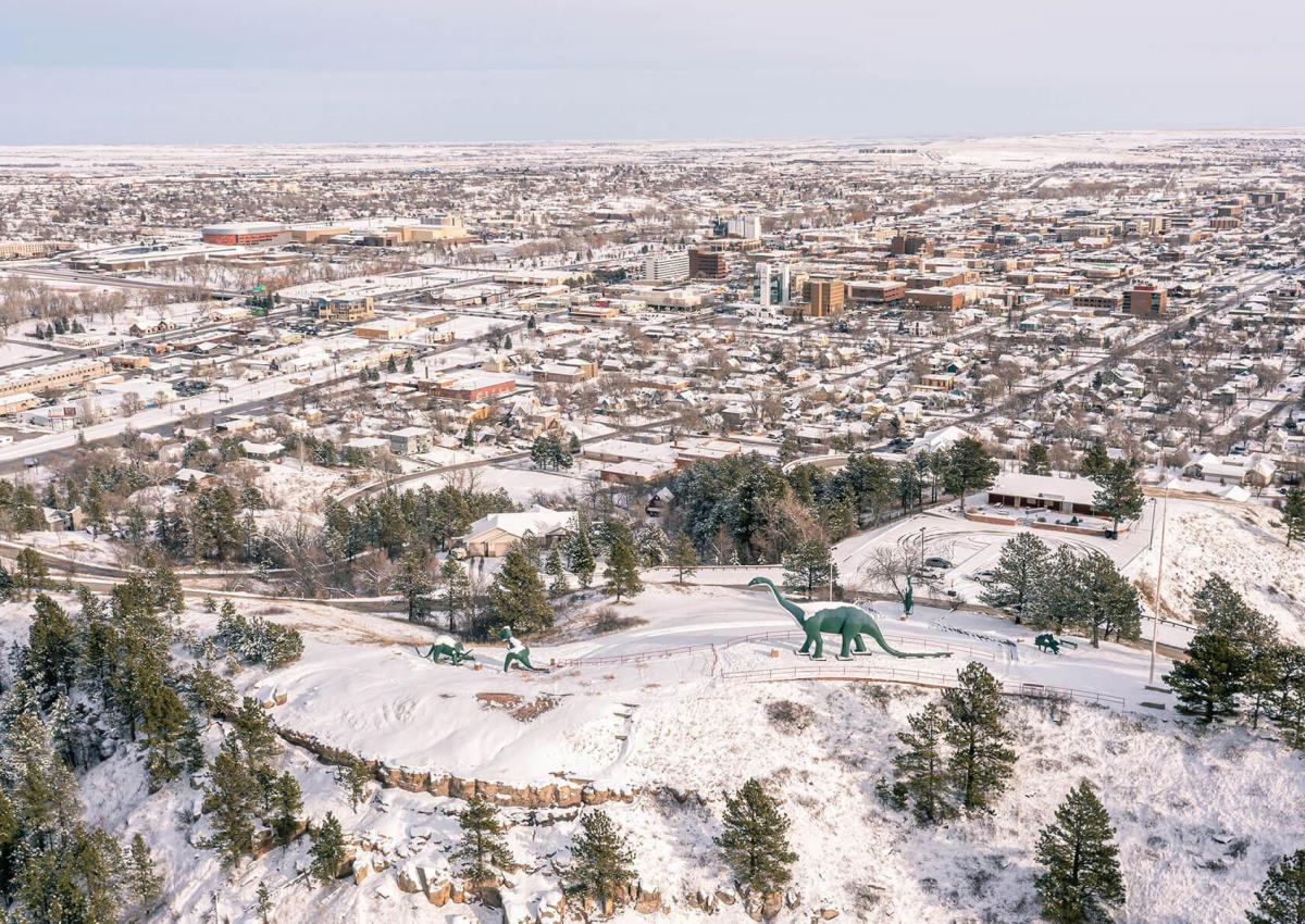 Snowy drone view of Dinosaur Park overlooking Downtown Rapid City