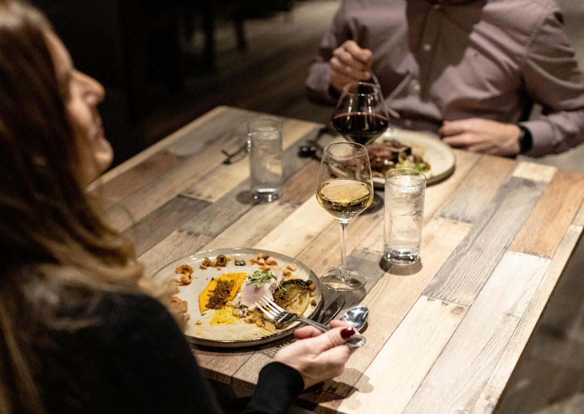 couple enjoying world cuisine entree options from local restaurant tandoor bocado in rapid city,sd