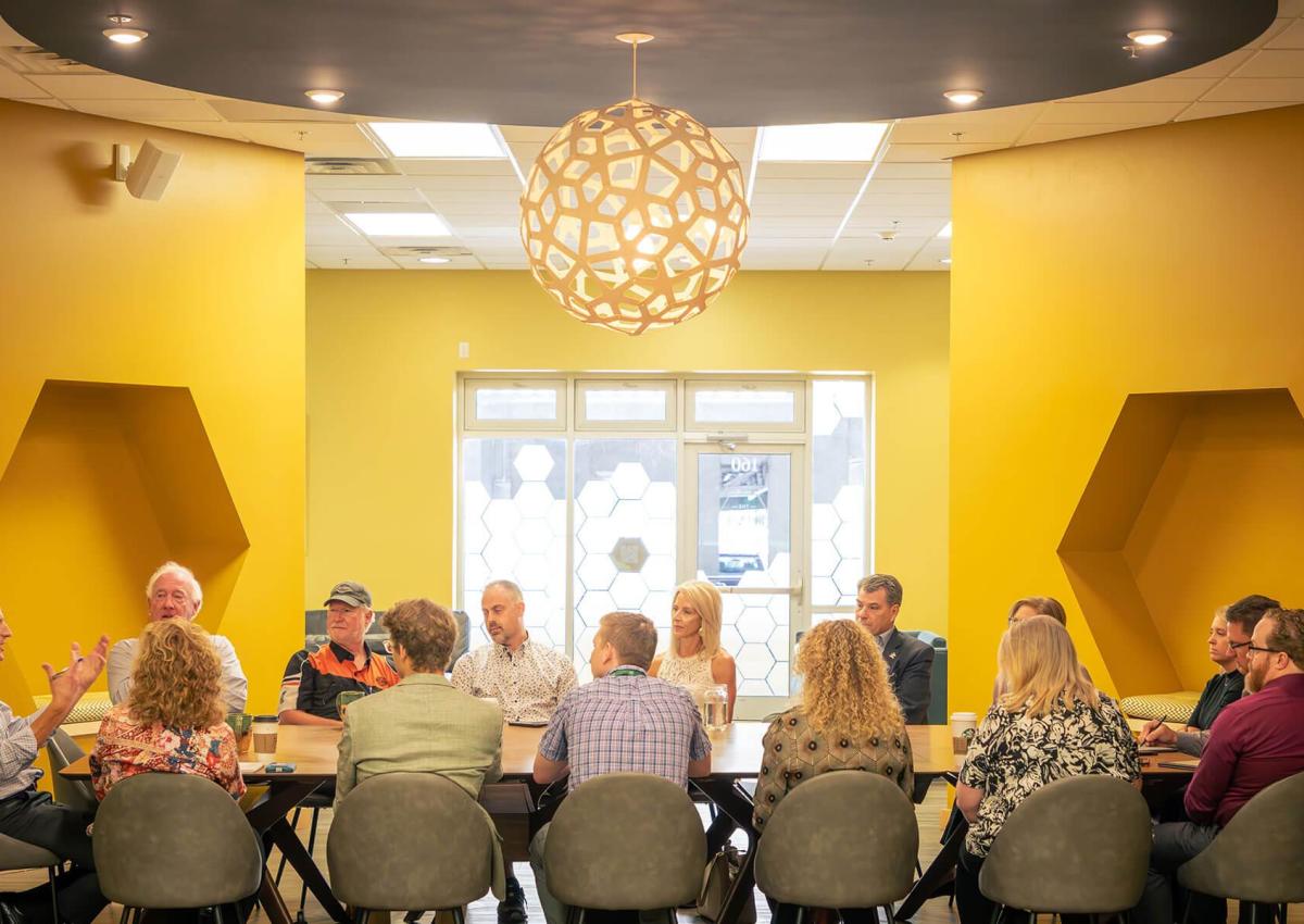 group at the conference table in the hive meeting space in main street square