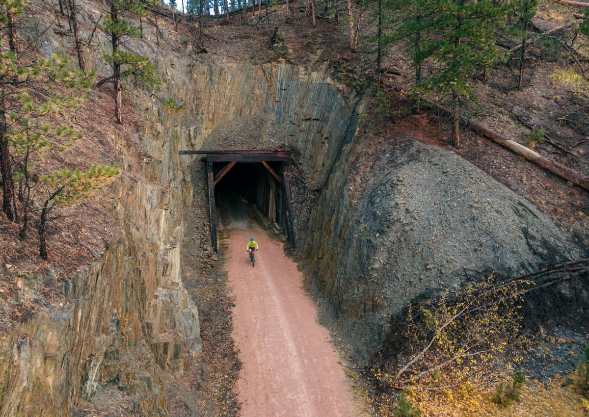 biker exiting the tunnel found along the mickelson trail in the black hills of south dakota