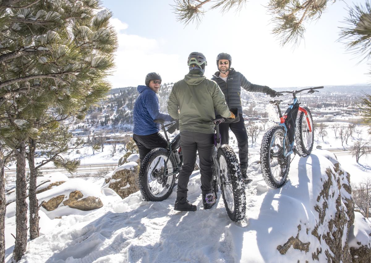 three fat tire bikers taking a break and enjoying the wintery views from M Hill in Rapid City, SD
