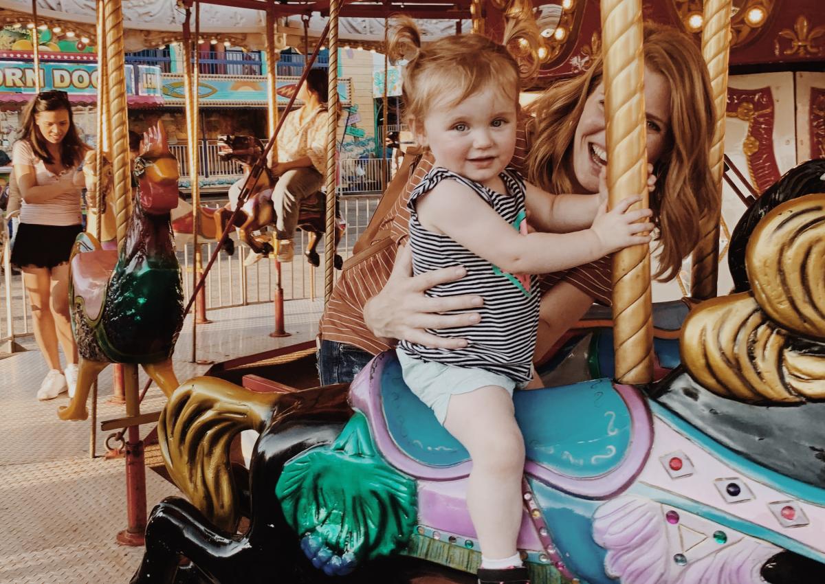 little kid riding the carousel ride at the central states fair in rapid city, sd