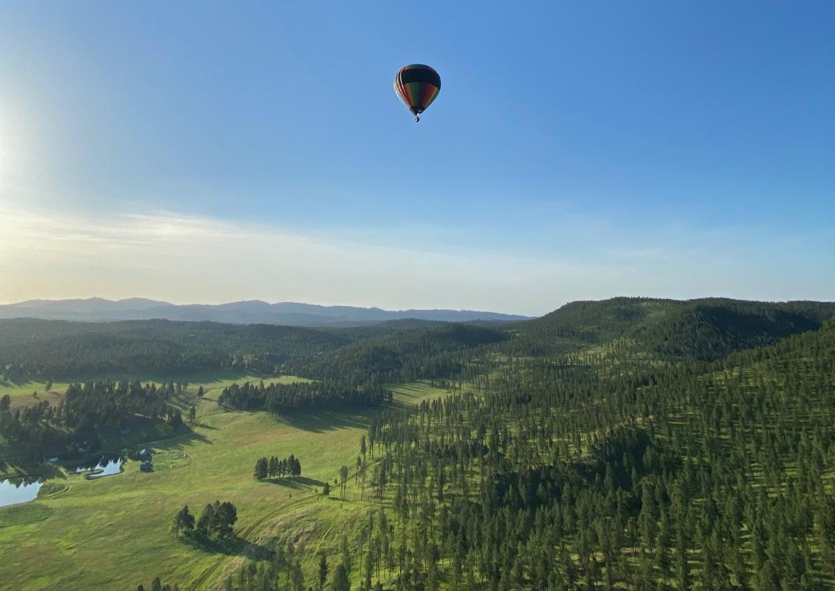 view of hot air balloon over the black hills from the basket of black hills balloons