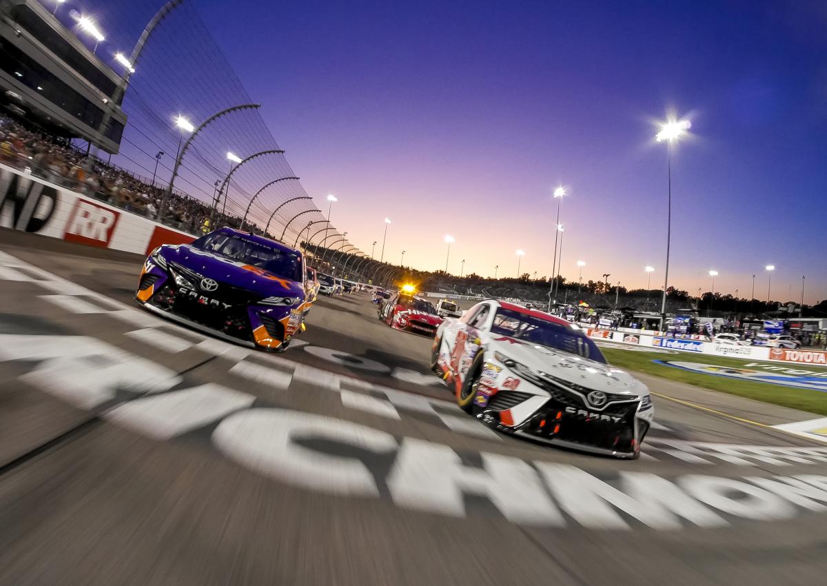 Race cars cross the finish line at Richmond Raceway in a 2017 NASCAR race