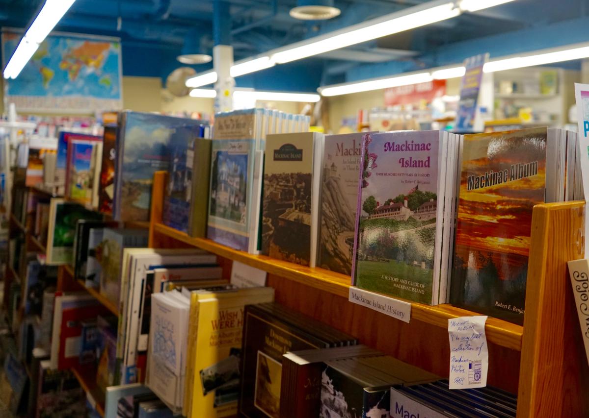 A shelf at The Island Bookstore has historical books including titles by Mackinac Island photographer Robert E. Benjamin