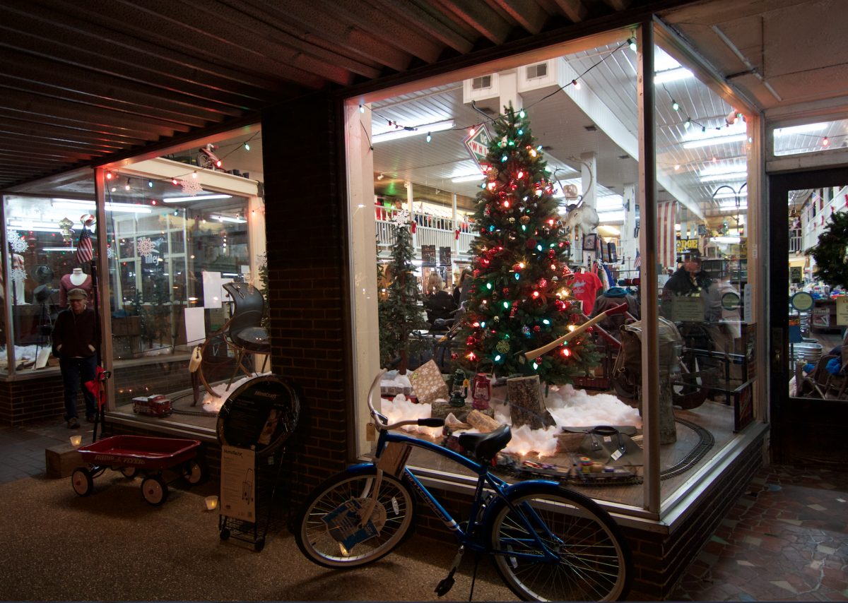 A Christmas tree adorns a street-level business window during the Sippin’ Cider Festival in downtown Athens
