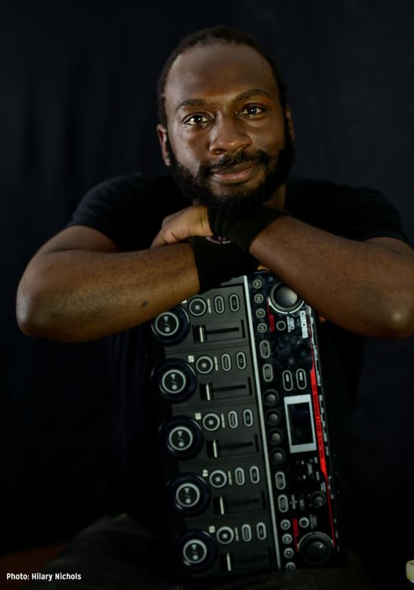 Musician Ki5 leaning on his sound mixer