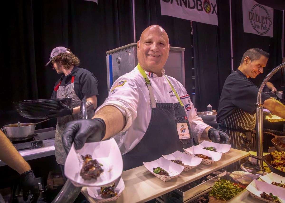 A chef serves up wings during Wingapalooza at INTRUST Bank Arena