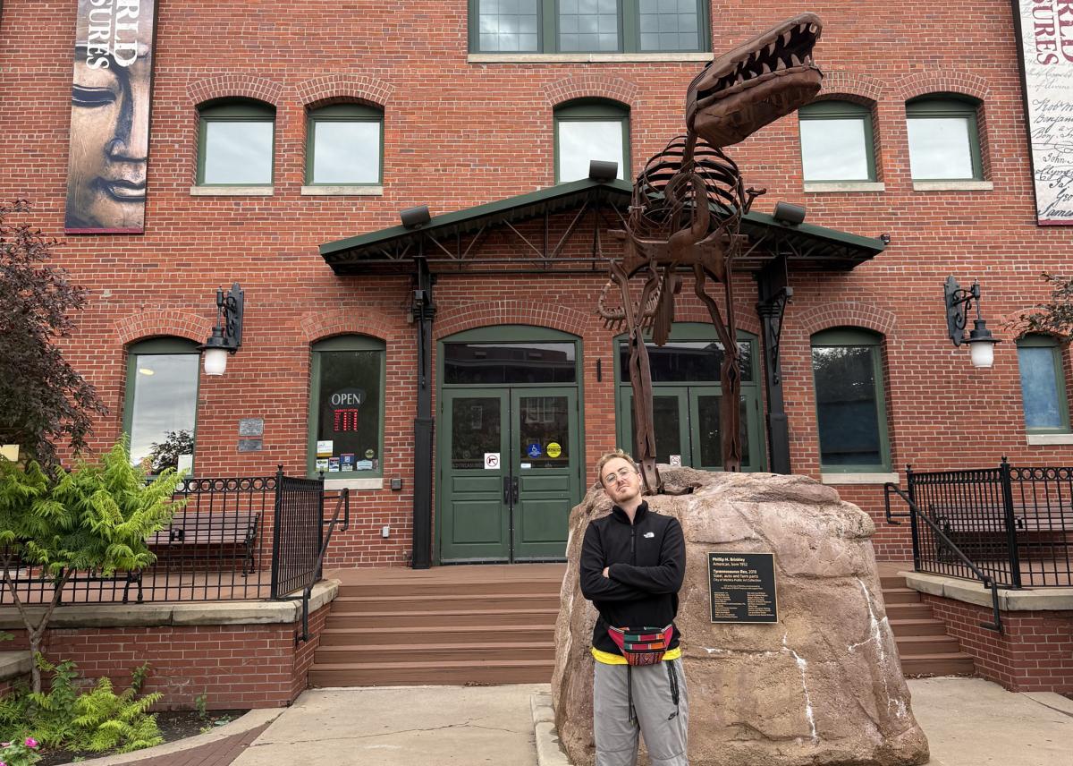 A German traveler visit Wichita during the World Cup takes a photo in front of the Museum of World Treasures.