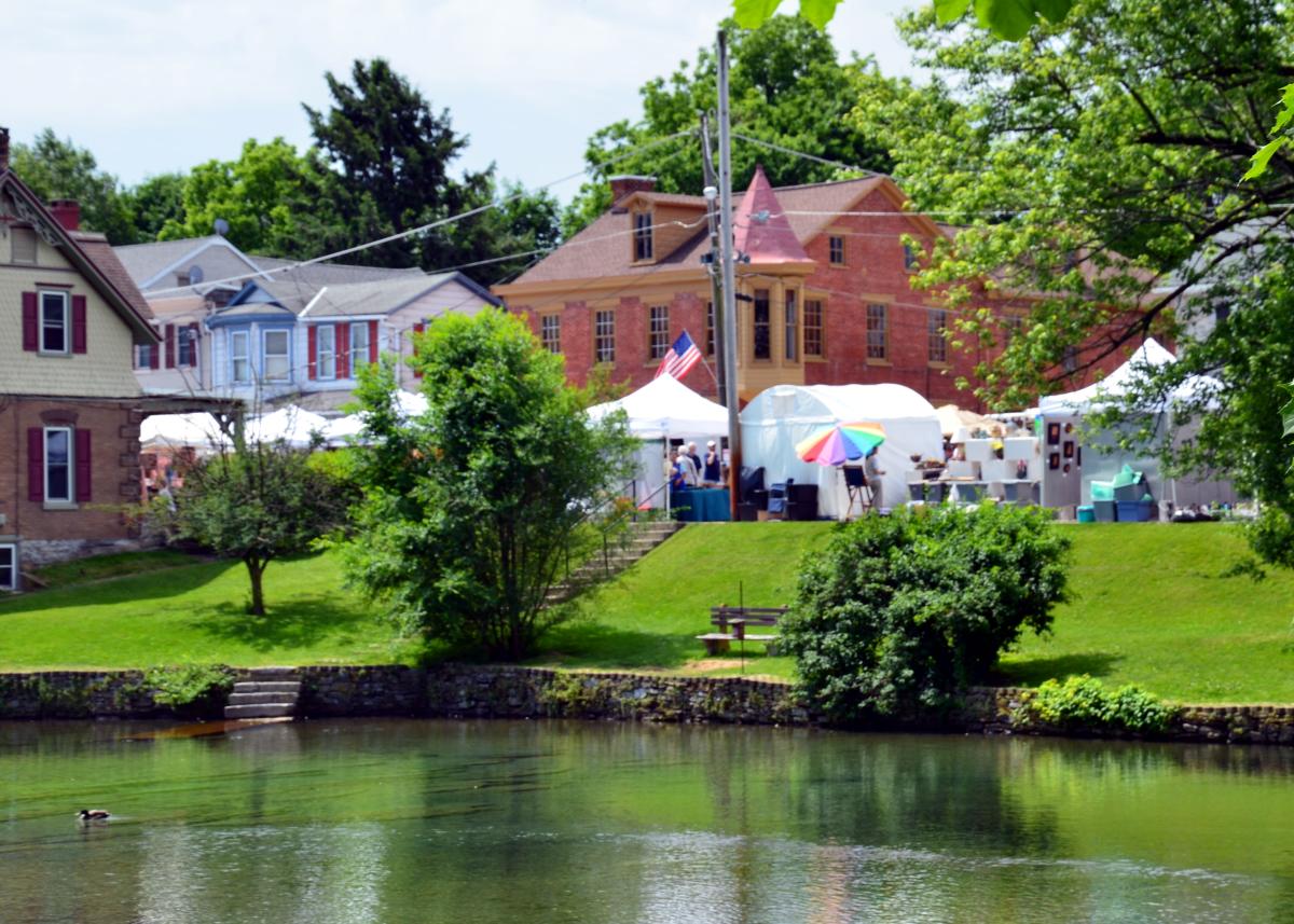 White tents and pond at the Foundry Day Arts and Crafts Festival in Boiling Springs, PA