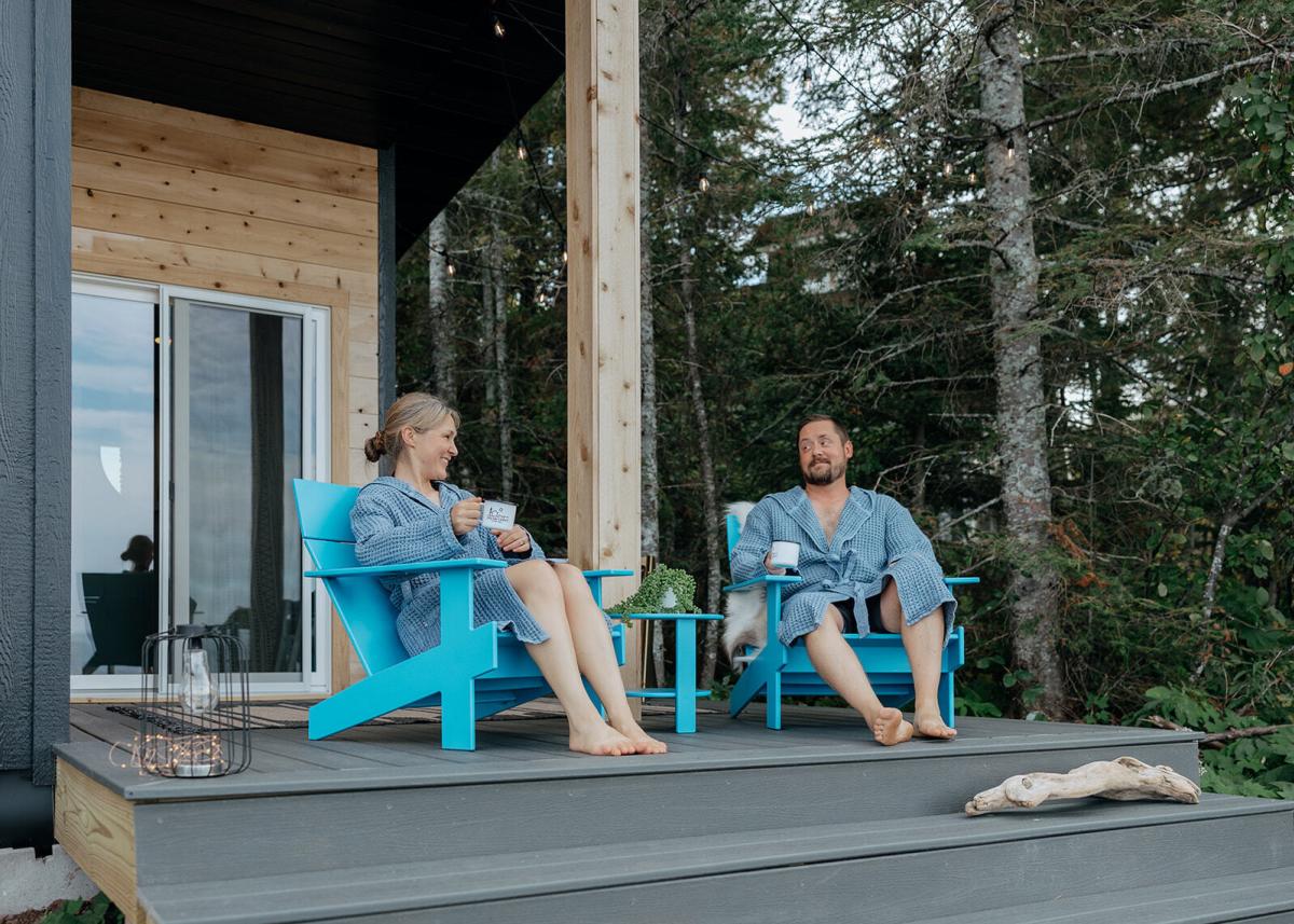 Couple sits outside sauna to relax and hydrate.