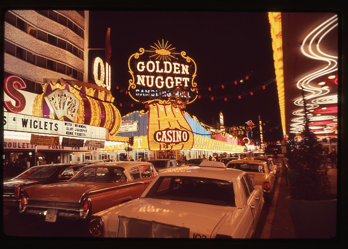 A vintage scene of cars and casinos along the Las Vegas Strip.