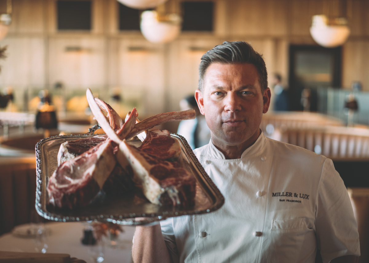 Celebrity chef Tyler Florence holds up a tray of chopped ribs