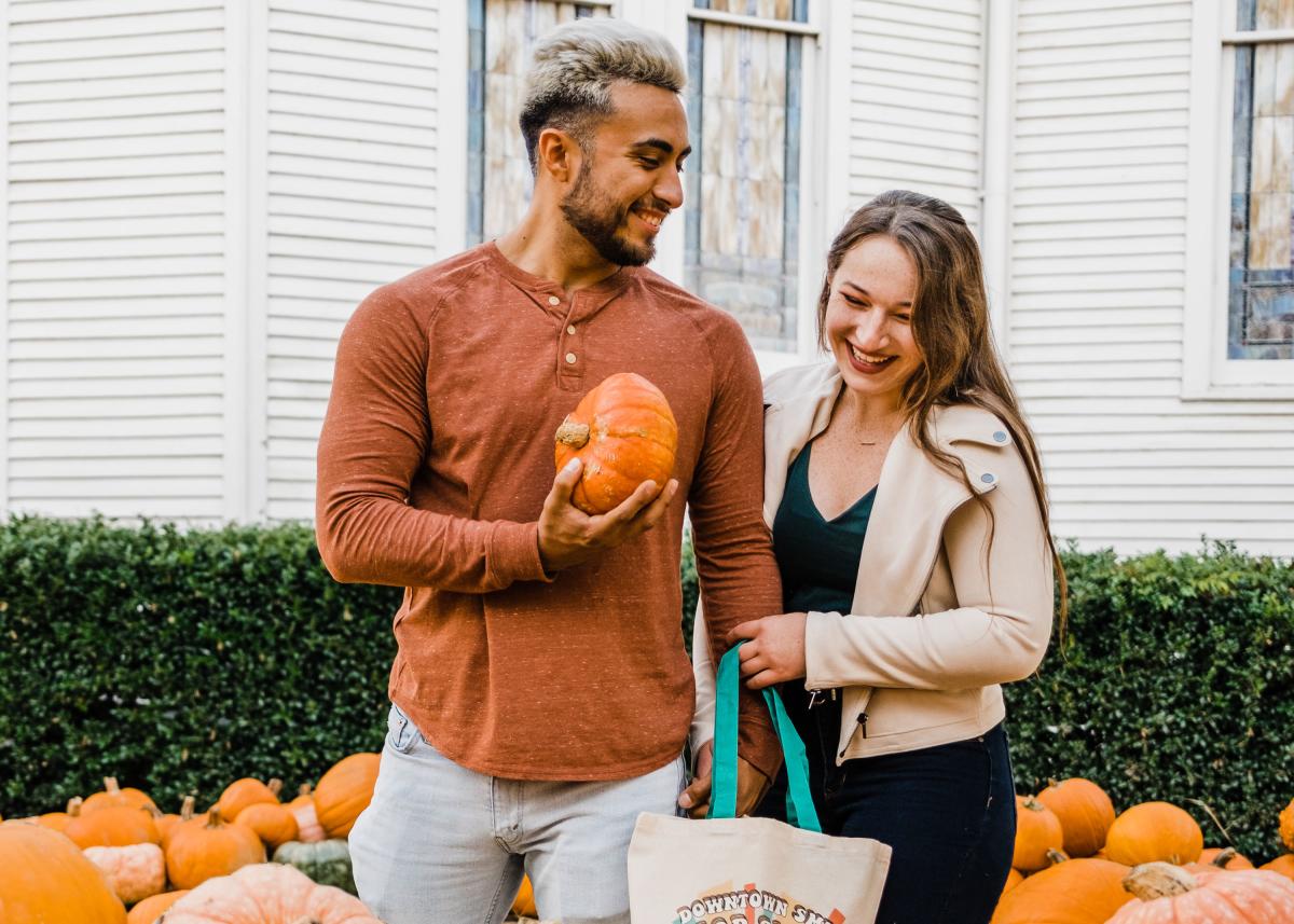 A happy couple visiting the pumpkin patch in Downtown San Marcos, Texas
