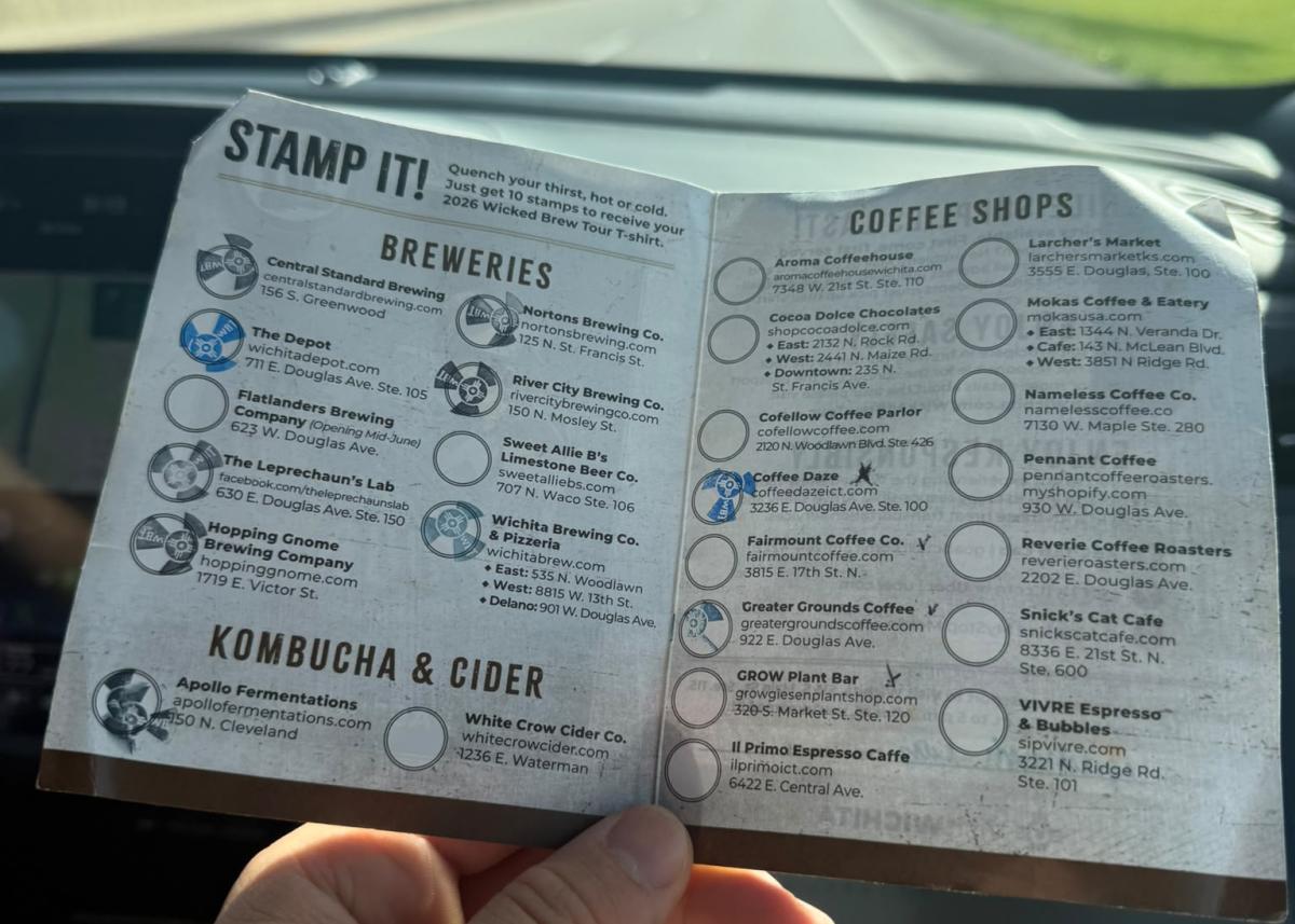 A German visitor holds a Wicked Brew Tour passport for the 2026 tour while visiting Wichita during the World Cup.