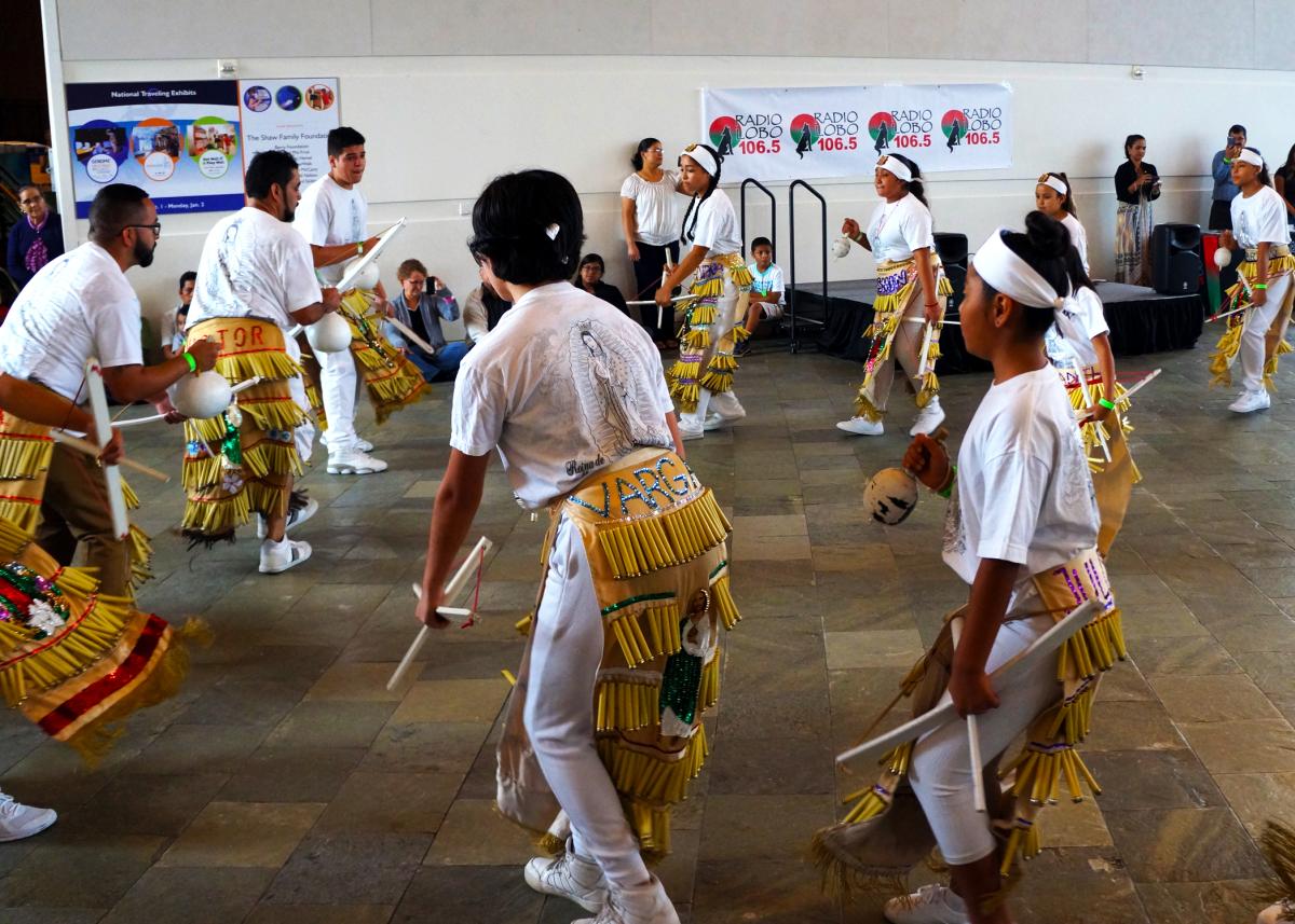 Hispanic men dance during Fiesta Hispana at Exploration Place