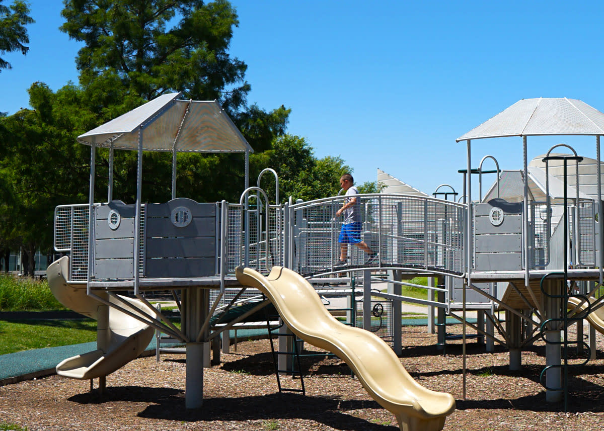 A child plays on the playground equipment at Exploration Park at Exploration Place