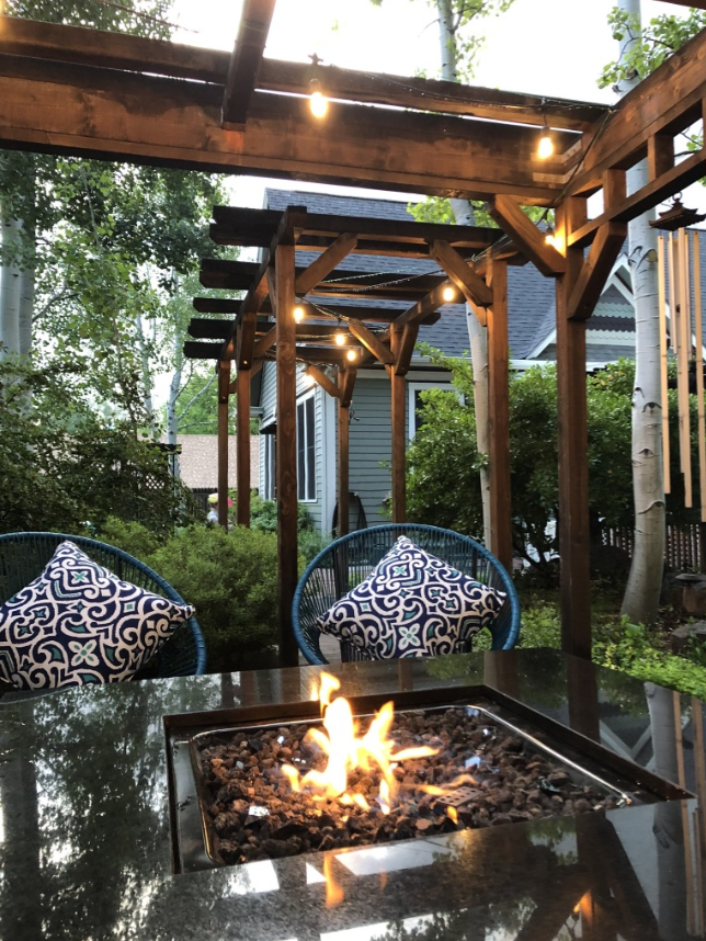 Pergola with twinkle lights and a firepit
