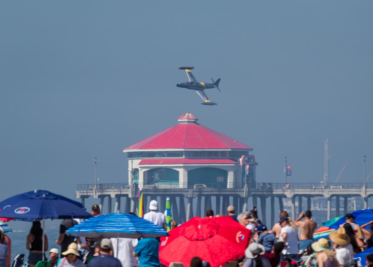 Pacific Airshow. Airplane flying over the Huntington Beach Pier