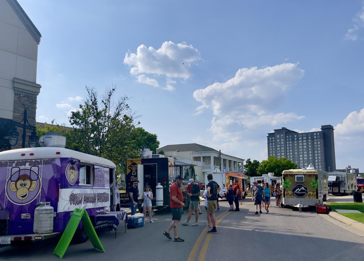 Visitors of the Final Friday Food Truck Rally line up to purchase food at trucks parked near the Boathouse in downtown Wichita