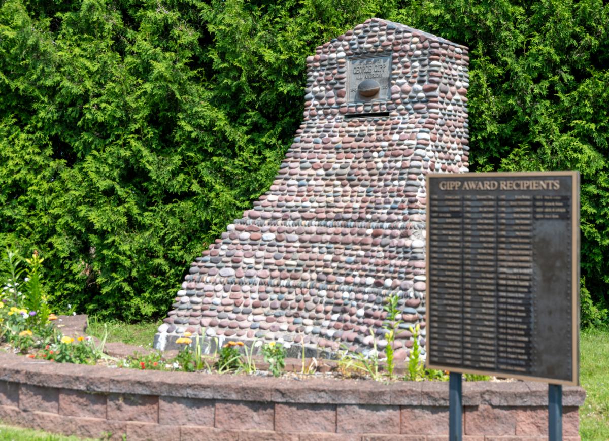 a monument made of stones affixed with a football mark a memorial site