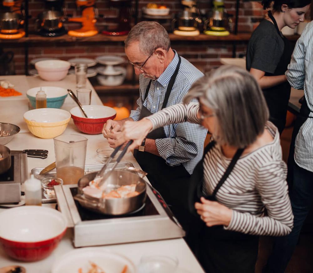 A couple takes a cooking class at Ginger and Baker