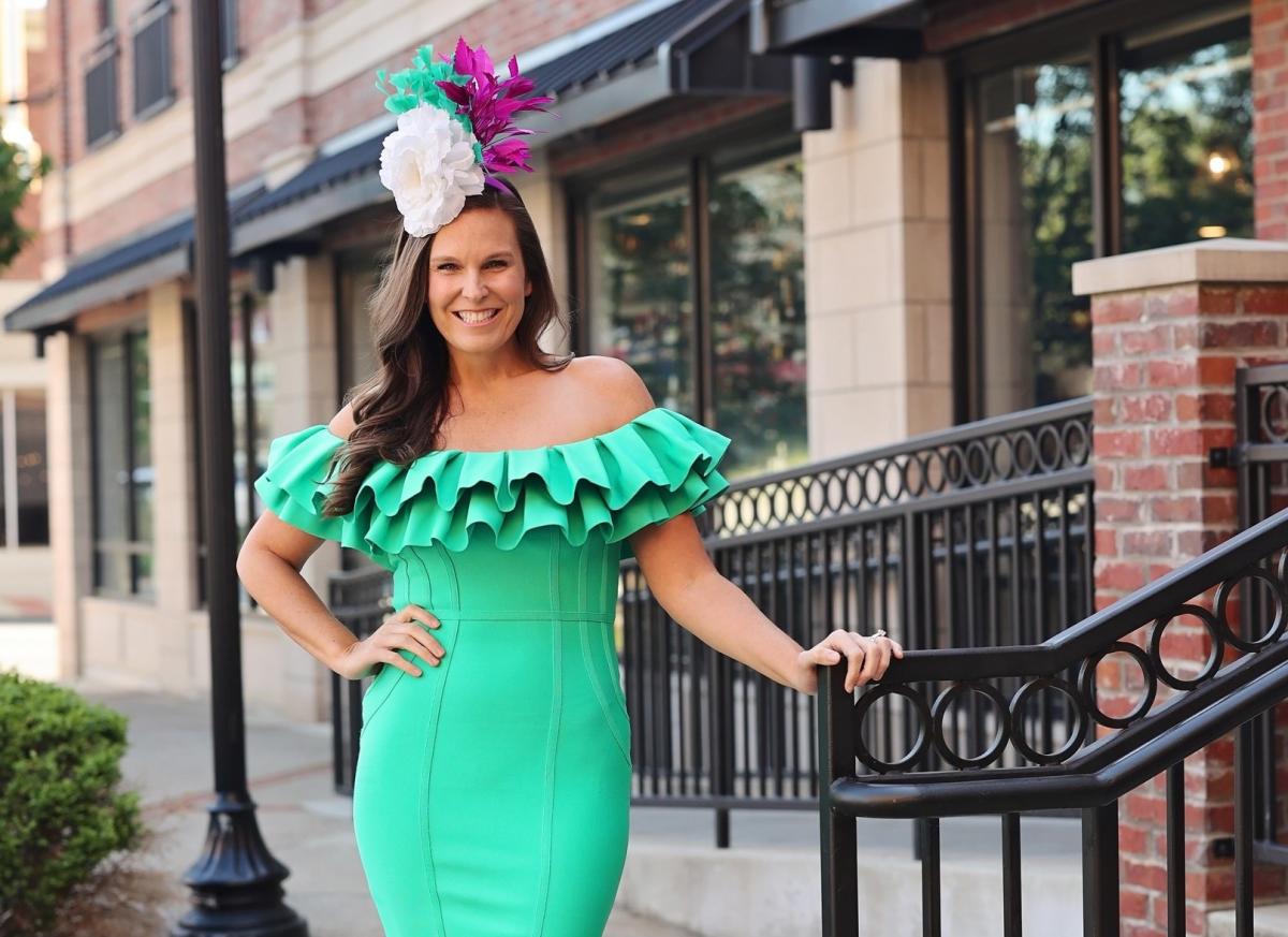 a woman wearing a bright green dress and derby fascinator in downtown elizabethtown