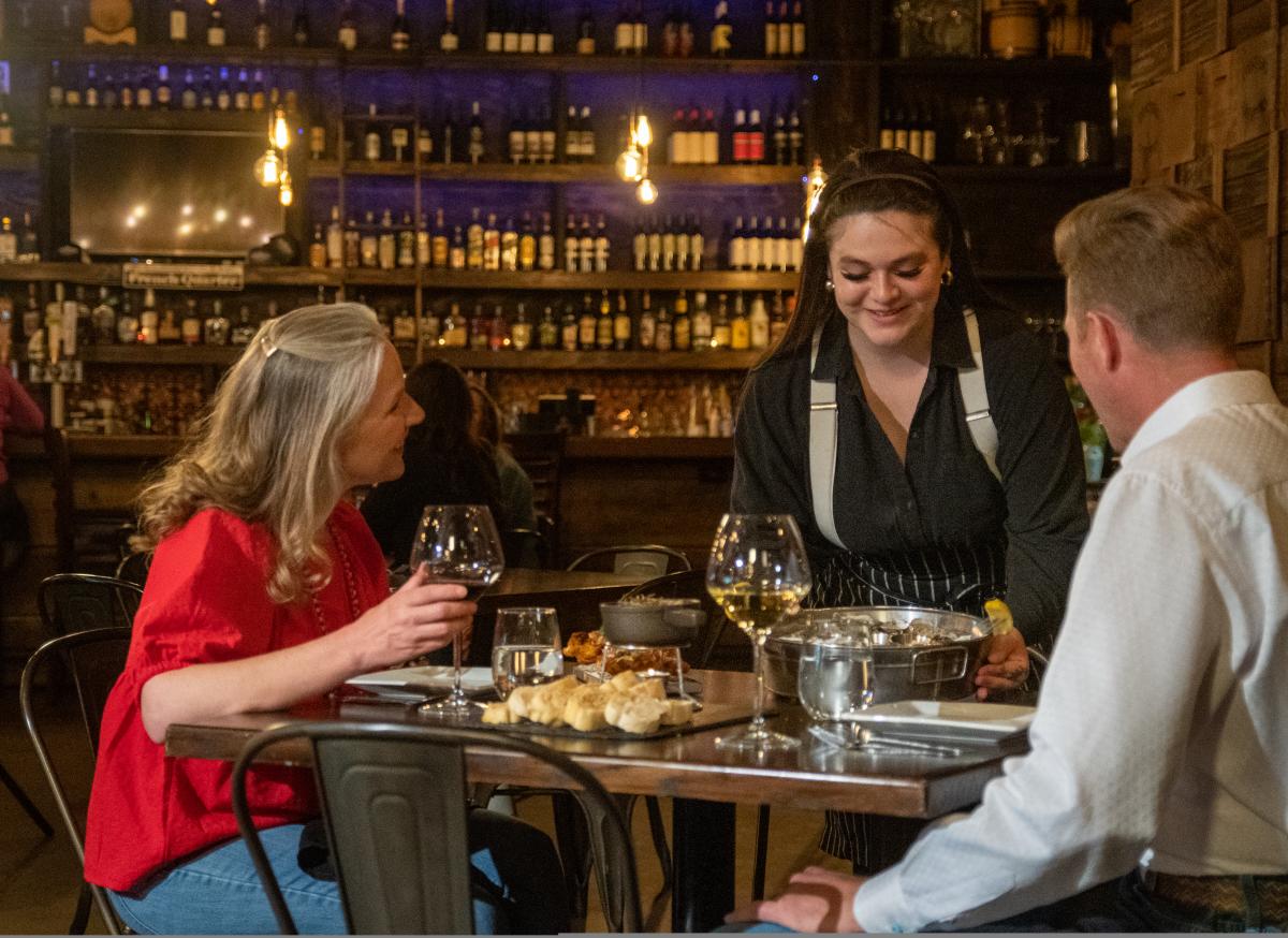 Couple getting served oysters and seafood at The Drunken Oyster