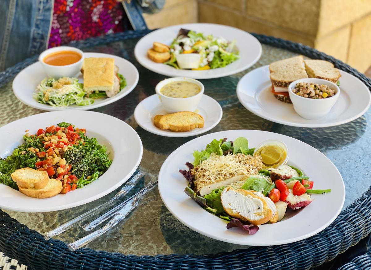 A patio lunch featuring a plate of Katherine's Pecan-Parmesan Crusted Chicken Salad.