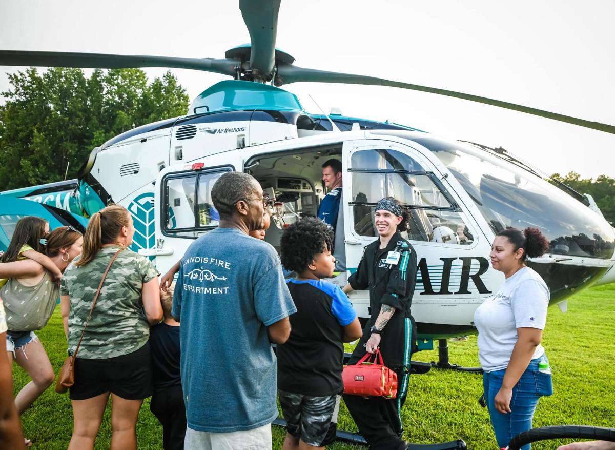 Crowd of people around helicopter
