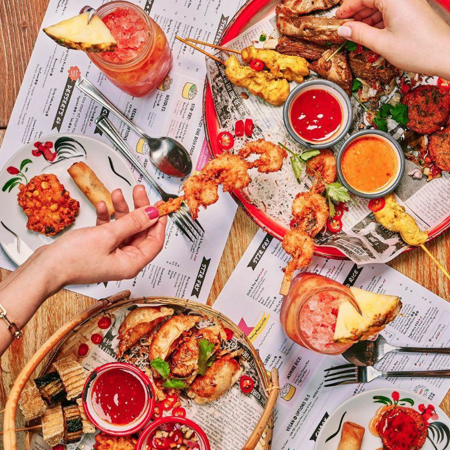 People sharing food at Thaikhun, Westquay